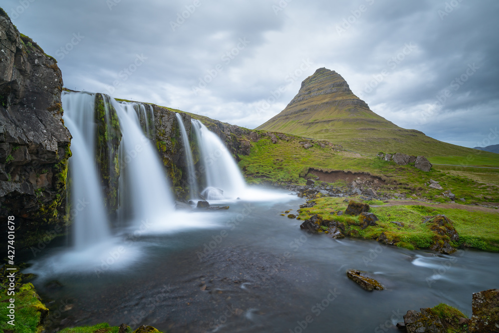 Icelandic waterfall with Kirkjufell mountain in the background.