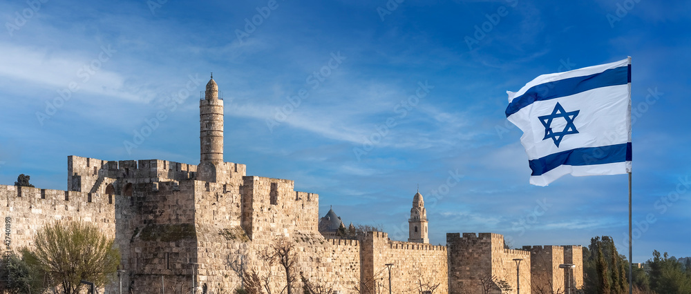 Obraz premium Panorama of Jerusalem Citadel near the Jaffa Gate with Tower of David, ancient fortress walls and Israeli flag