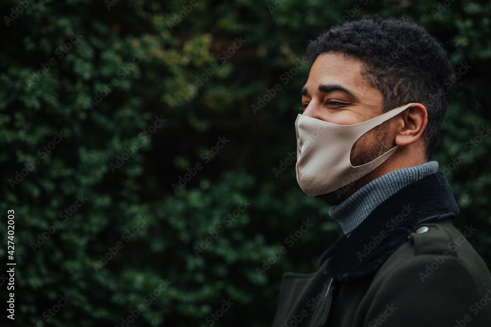 Afro male wearing face mask outdoors
