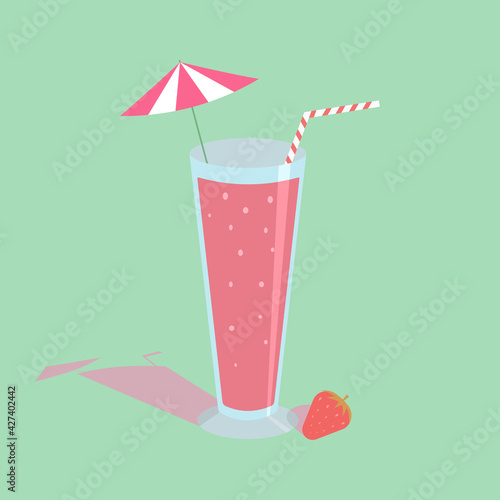 Strawberry juice blended in a glass with an umbrella and straw With strawberries on the side On a green background