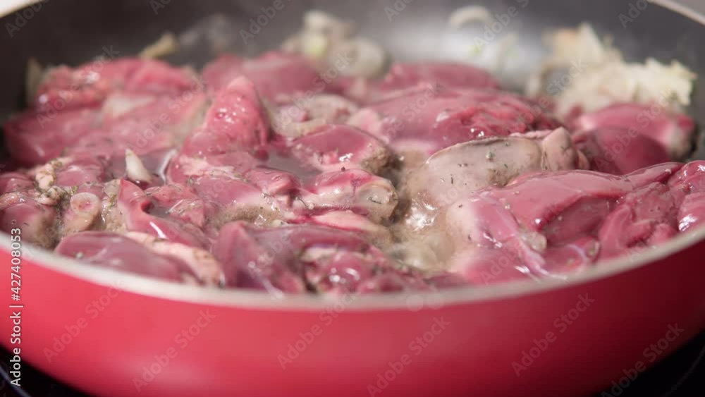 Cooking fried liver in a frying pan close-up. selective focus Cooking fried liver in a frying pan close-up. selective focus