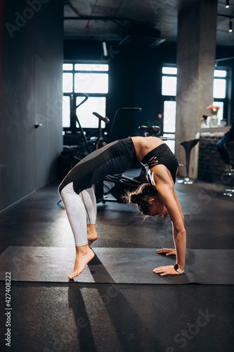 Slim athletic woman doing exercise bridge at gym © teksomolika