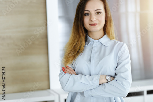 Business woman headshot in sunny office. Unknown businesswoman standing straight with tablet computer. Young accountant or secretary looks good Free Download Business woman headshot in sunny office. Unknown businesswoman standing straight with tablet computer. Young accountant or secretary looks good - GFXLoad