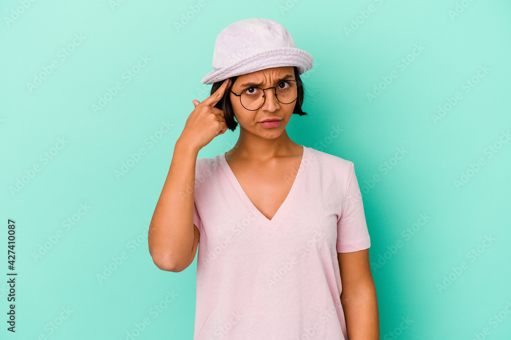 Young mixed race woman isolated on blue background pointing temple with finger, thinking, focused on a task.
