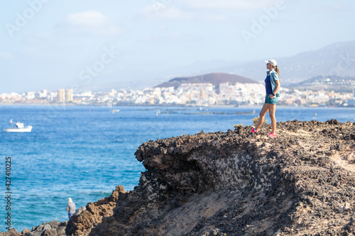 Young woman enjoying summer vacation near ocean