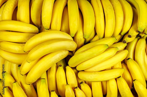 Background of many banana pieces, overhead view, studio food photography.