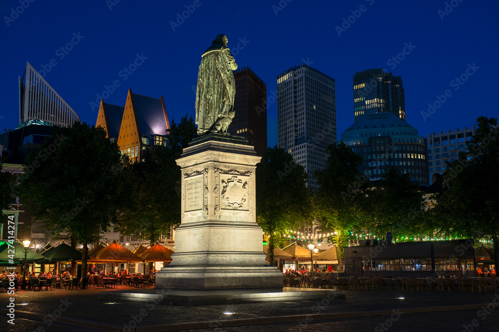 Statue of Willem de Zwijger on het Plein in The Hague, Holland, with the skyline of the city visible in the background