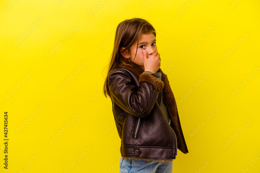 Little caucasian girl isolated on yellow background scared and afraid. Little caucasian girl isolated on yellow background scared and afraid.