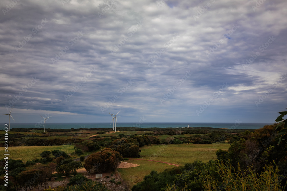 Australian landscape featuring row of wind turbines along the coast line at Cape Nelson, Portland Victoria Australia Australian landscape featuring row of wind turbines along the coast line at Cape Nelson, Portland Victoria Australia