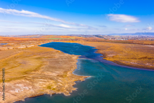 Aerial view about rocky seashore with turquoise waving water.