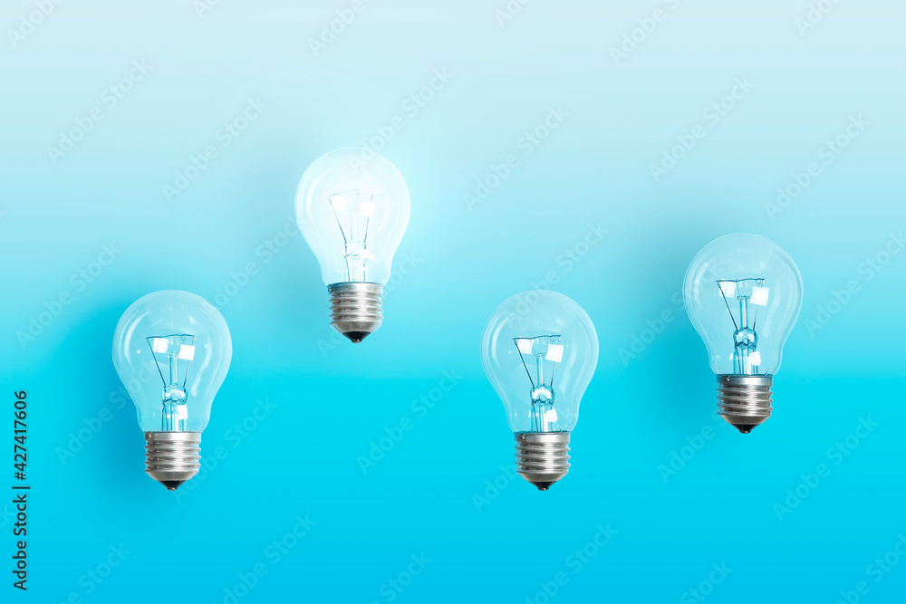 lit light bulb floating above others lit light bulb floating above others