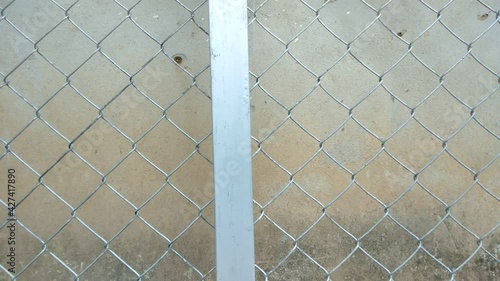 The gray metal door is moving to the right, the background is an old concrete.