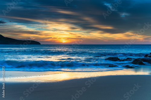 Sunrise at the beach with high cloud © Merrillie