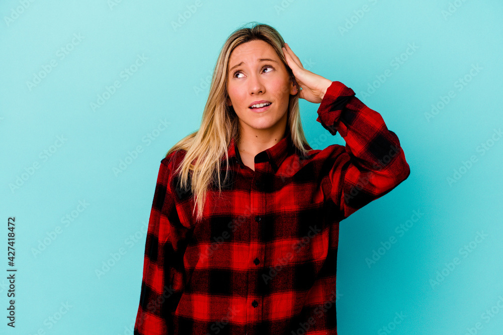 Young mixed race woman isolated on blue background being shocked, she has remembered important meeting. Young mixed race woman isolated on blue background being shocked, she has remembered important meeting.