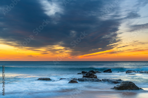 Sunrise at the beach with high cloud