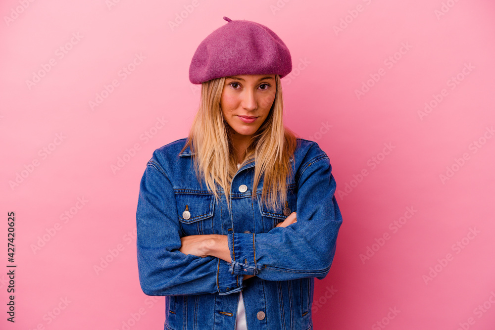 Young mixed race woman isolated on pink background who feels confident, crossing arms with determination. Young mixed race woman isolated on pink background who feels confident, crossing arms with determination.