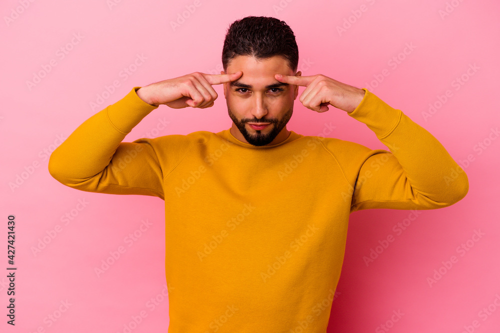 Young mixed race man isolated on pink background Young mixed race man isolated on pink background