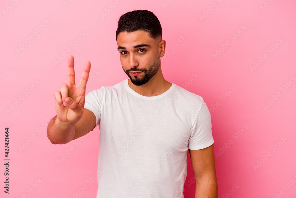 Young mixed race man isolated on pink background Young mixed race man isolated on pink background