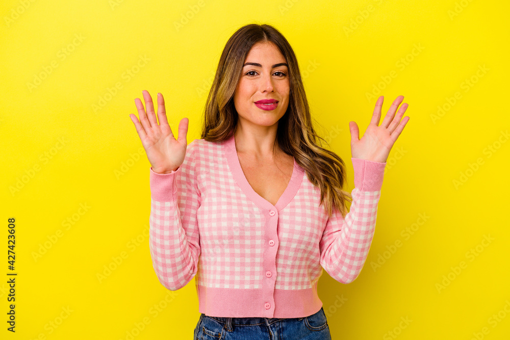 Young caucasian woman isolated on yellow background Young caucasian woman isolated on yellow background
