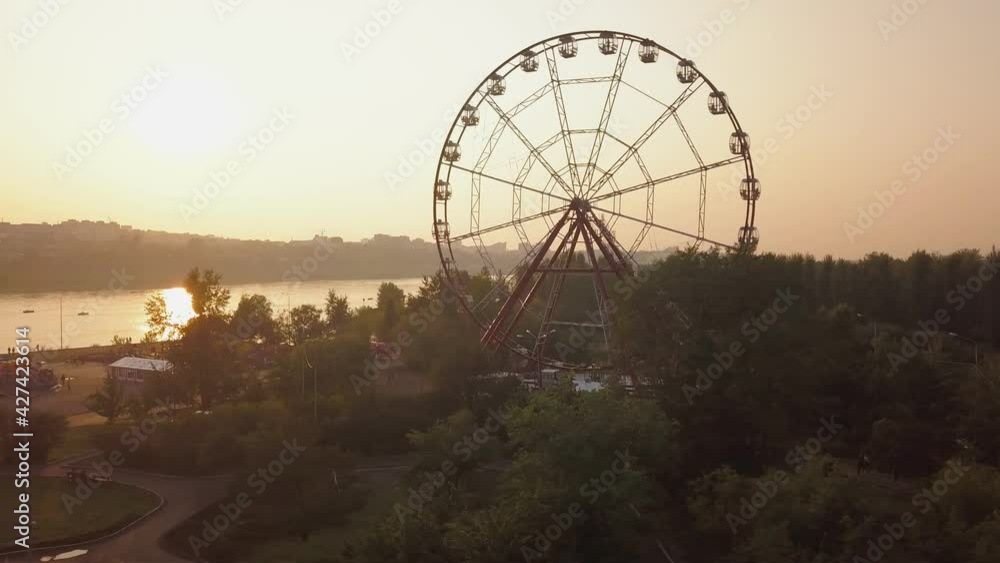 Ferris wheel in an amusement park at sunset Ferris wheel in an amusement park at sunset