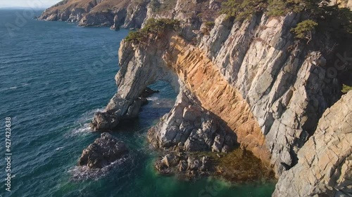 Wallpaper Mural Mountains and rocks near the ocean. Rising above sea level, beautiful mountains and rocks against the backdrop of blue sky and clear sea water Torontodigital.ca