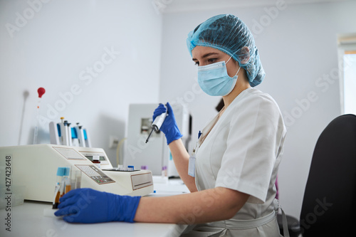 Photography Focused lab technician preparing clinical specimens for a coagulation analysis