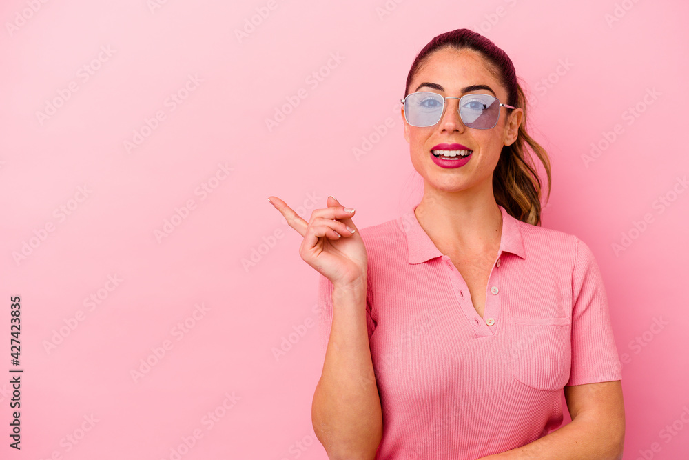 Young caucasian woman isolated on pink background