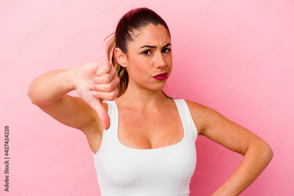 Young caucasian woman isolated on pink background