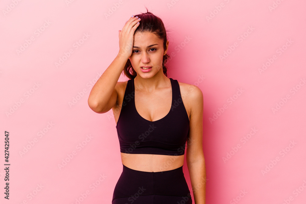 Young sport Indian woman isolated on pink background tired and very sleepy keeping hand on head. Young sport Indian woman isolated on pink background tired and very sleepy keeping hand on head.