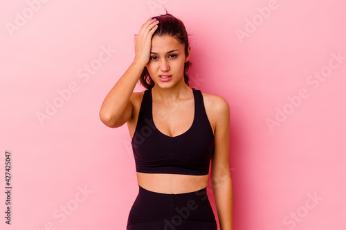 Young sport Indian woman isolated on pink background tired and very sleepy keeping hand on head.
