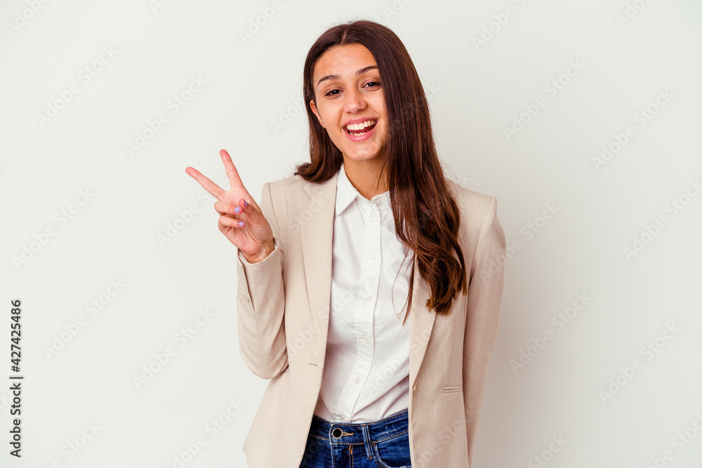 Young Indian business woman isolated on white background joyful and carefree showing a peace symbol with fingers.