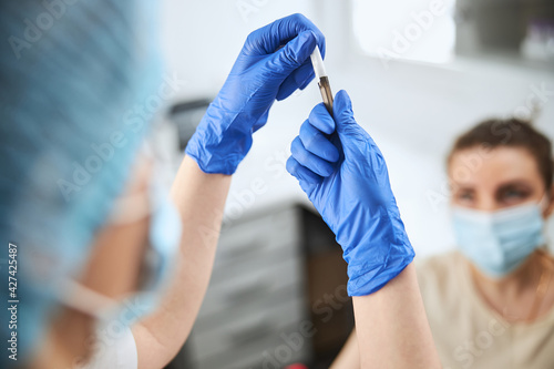 Nurse assembling the syringe needle and a vacuum tube holder