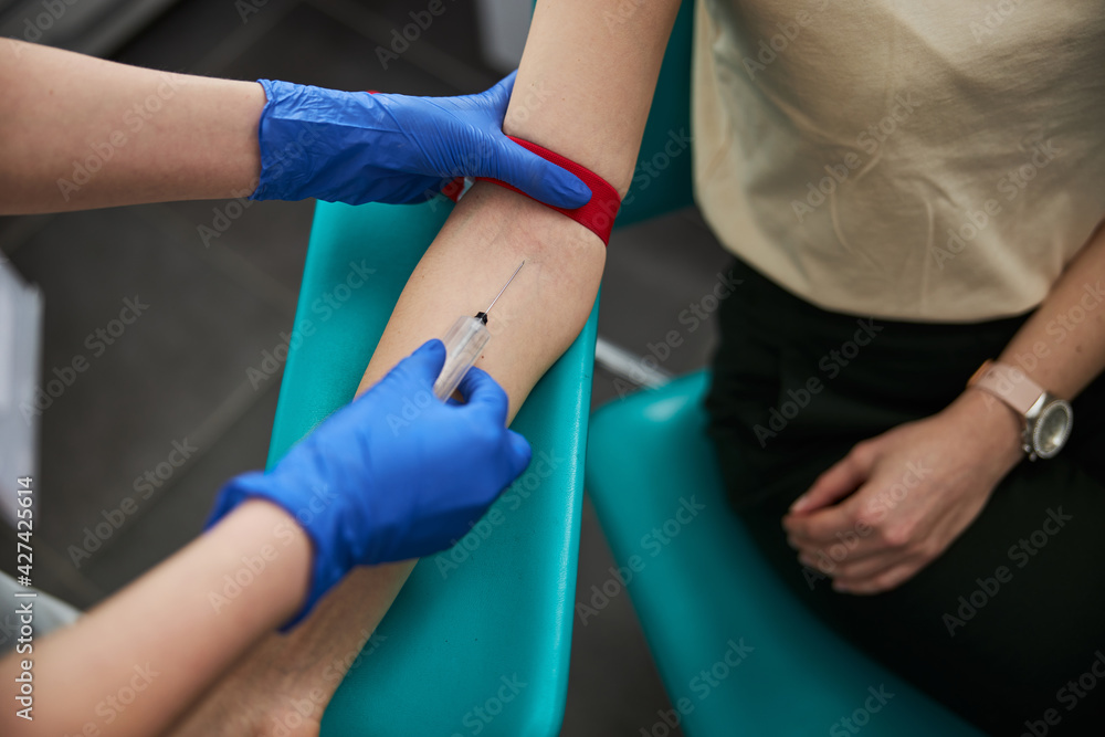 Phlebotomist drawing blood for a laboratory test Phlebotomist drawing blood for a laboratory test