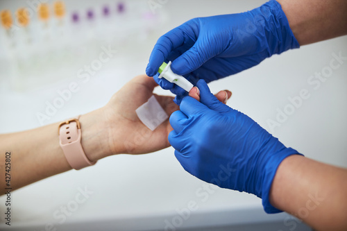 Canvas Print Lab technician performing a skin puncture procedure