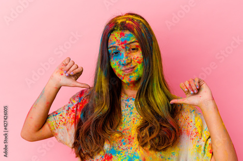 Young Indian woman celebrating holy festival isolated on white background feels proud and self confident, example to follow.