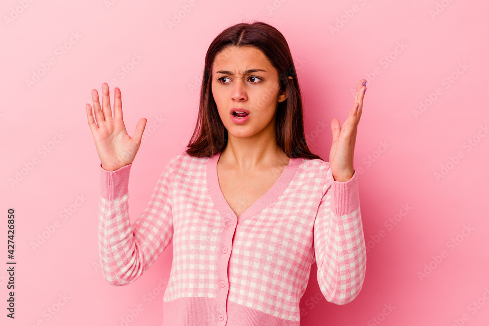 Young Indian woman isolated on pink background screaming to the sky, looking up, frustrated. Young Indian woman isolated on pink background screaming to the sky, looking up, frustrated.