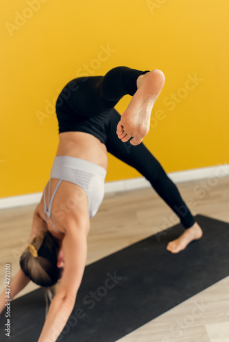 A young woman performs the difficult bridge pose in yoga. Bow pose. Yoga and healthy lifestyle concept photo