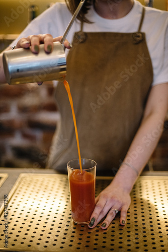 Bartender preparing Bloody Maria cocktail.