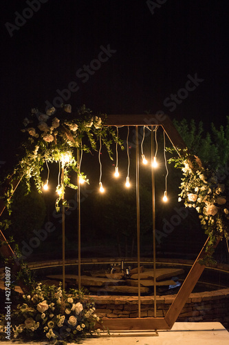Wedding ceremony with arch in rustic style with fresh flowers and macrame
