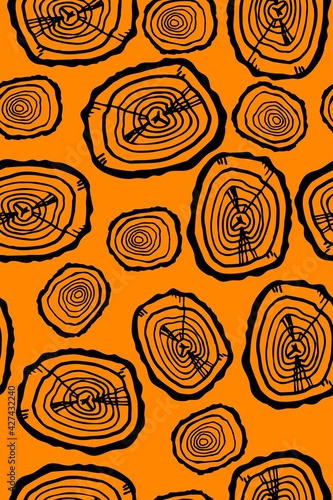 Hand drawn texture of a cut tree in a circle with serifs and wooden rings indicating the age of the tree on an orange background. Seamless background for textiles, paper, packaging.