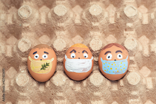 Creative Easter eggs with Corona virus (COVID19) protection concepts. Diverse chicken eggs with doodle faces wearing medical masks.
