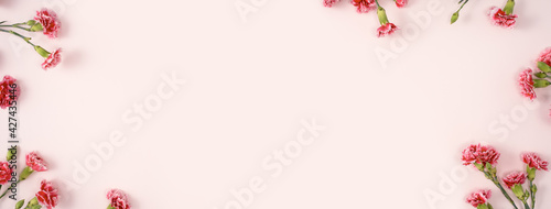 Design concept of Mother's day holiday greeting with carnation bouquet on pink table background