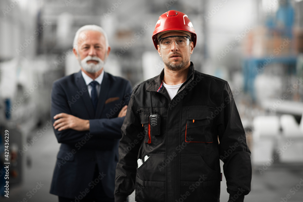 Architect and worker working on project. Colleagues working in factory. Architect and worker working on project. Colleagues working in factory.