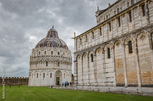 View of The Pisa Baptistery and The Pisa Cathedral (Duomo di Pisa) on Piazza dei Miracoli in Pisa, Tuscany, Italy.