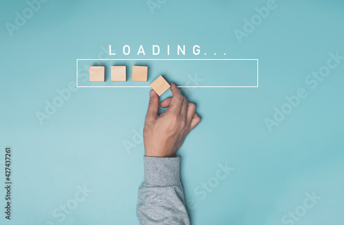 Hand putting wooden cube block with infographic for download on blue background , Technology and business progress concept. photo