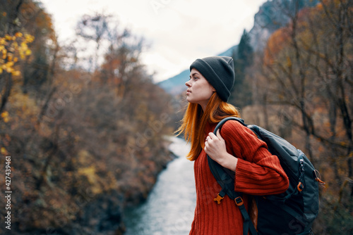 woman tourist backpack autumn forest river travel