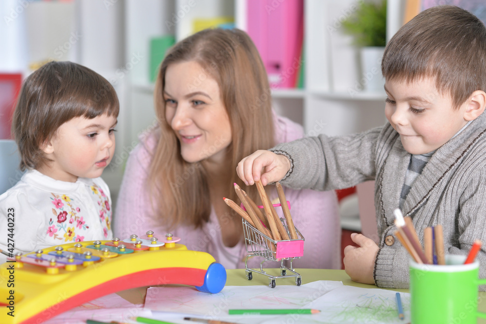 Fototapeta premium Mother with children playing together at home