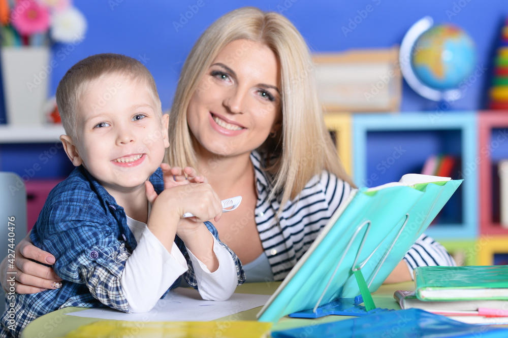 Fototapeta premium Mother with her son doing homework at home