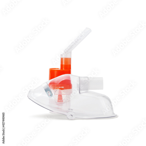 Respiratory mask and atomizing cup with nebulizer mouthpiece for compressor inhaler isolated on white background. Medical equipment for inhalation therapy for asthma and respiratory diseases. photo