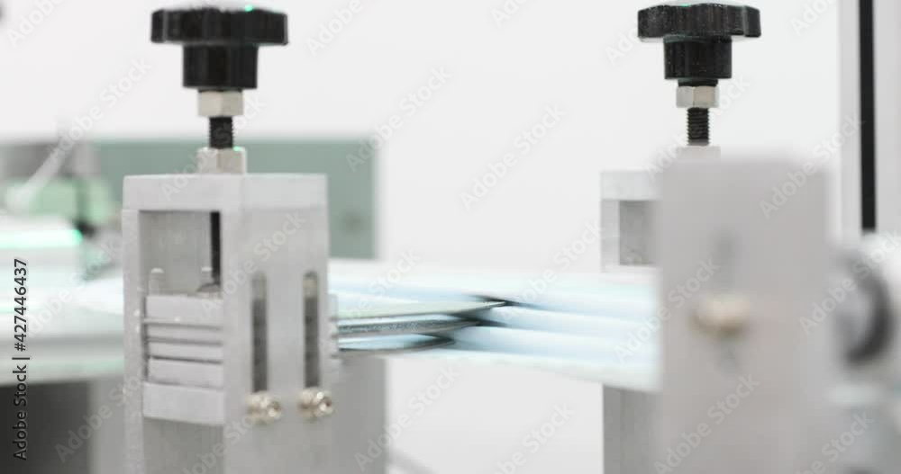 Process Of Manufacturing Line Production - Disposable Mask In Automated Machine With Folding Tools. - Pan Right, Slow Motion Process Of Manufacturing Line Production - Disposable Mask In Automated Machine With Folding Tools. - Pan Right, Slow Motion